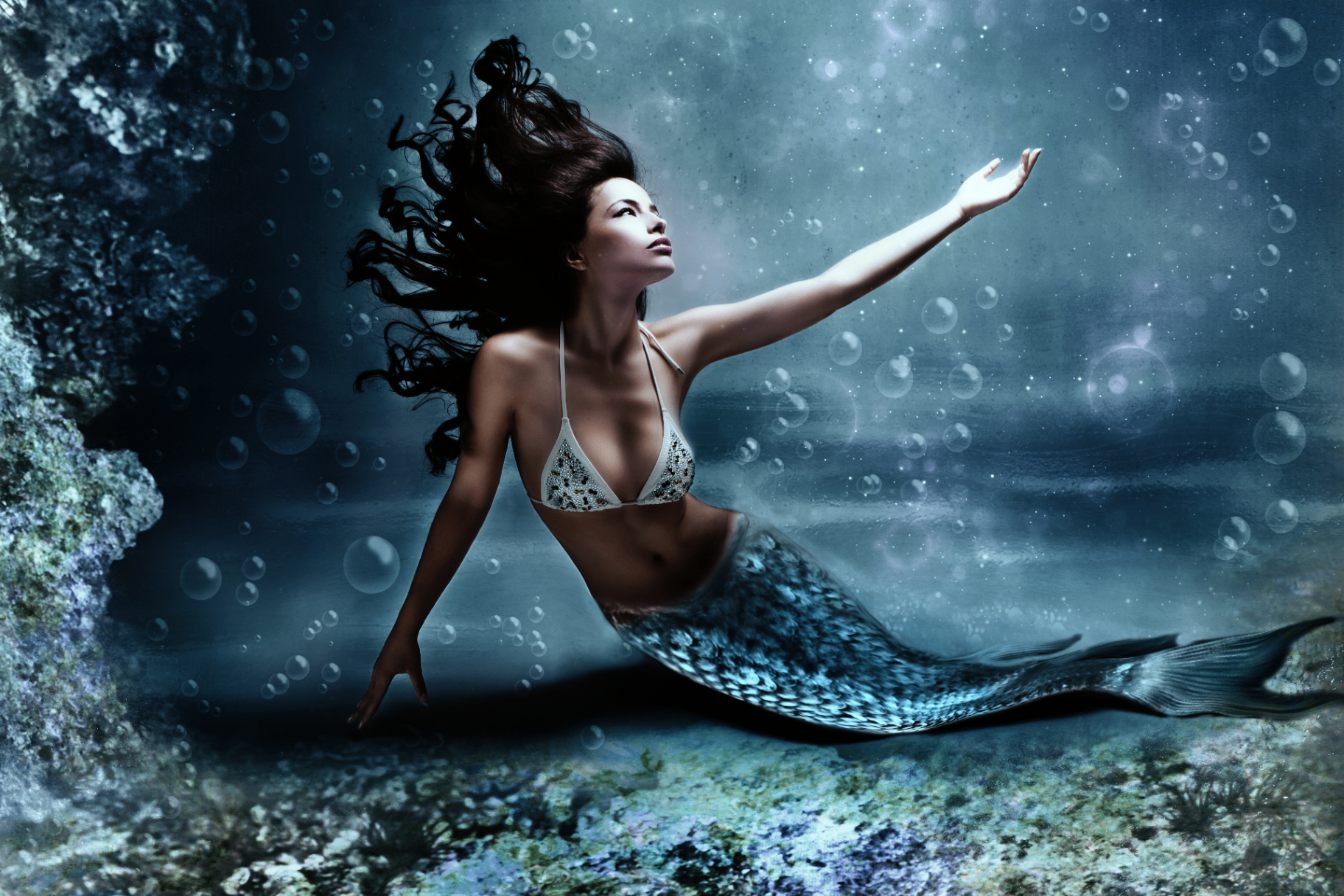 Mermaid rising through bubbles in a moonlit sea